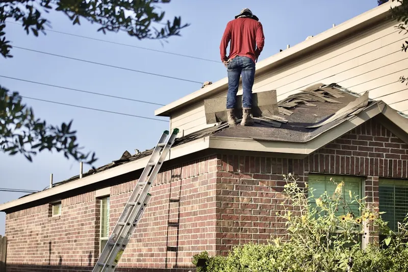 Professional roofer working on a residential roof in Fort Washington
